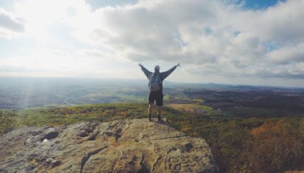 man on top of mountain