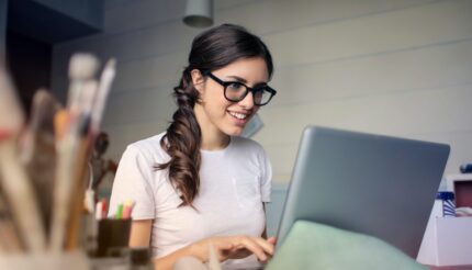 Woman on laptop smiling